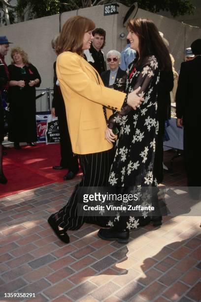 American singer and songwriter Suzy Bogguss and American singer and musician Kathy Mattea attend the 29th Annual Academy of Country Music Awards,...