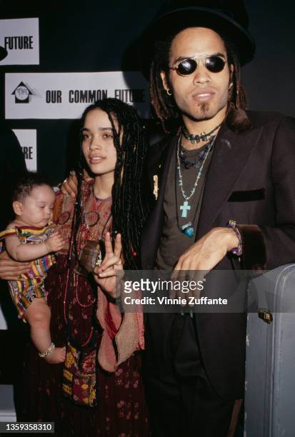American actress Lisa Bonet , holding her daughter, Zoe Kravitz, and her husband, American singer-songwriter and musician Lenny Kravitz attend an...
