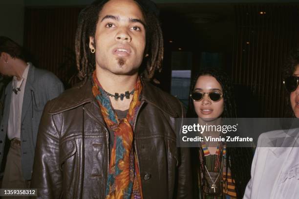 American singer-songwriter and musician Lenny Kravitz, wearing a brown leather jacket and a scarf, and American actress Lisa Bonet , wearing...