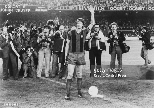 Photographers gather around the halfway line as Johan Cruyff from the Netherlands and Forward for Barcelona Football Club waves farewell and goodbye...