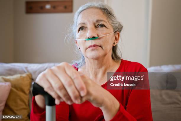 senior woman holding hands on walking stick - oxygen stock pictures, royalty-free photos & images
