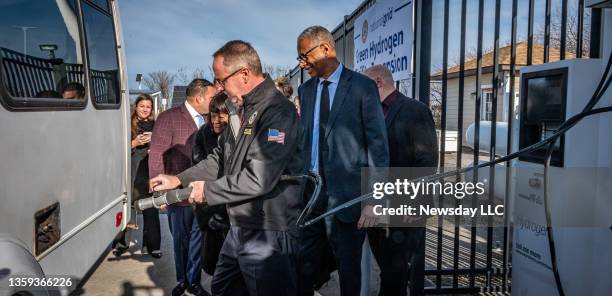 Town of Hempstead Supervisor Don Clavin, with Rudolph Wynter , President of National Grid New York, refueling one of the hydrogen fuel vehicles at...