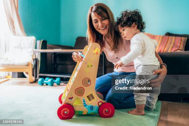 mother and toddler playing - baby walker stock pictures, royalty-free photos & images