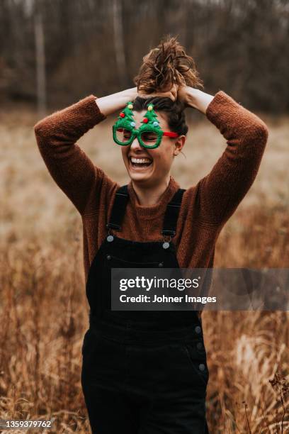 happy woman wearing christmas glasses - johner christmas bildbanksfoton och bilder