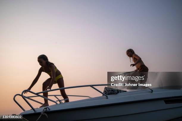 children standing on boat - motor boats stock pictures, royalty-free photos & images