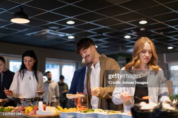 people choosing food in buffet - büfett stock-fotos und bilder