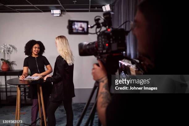 female news anchors reporting news in studio - tv studio stock pictures, royalty-free photos & images