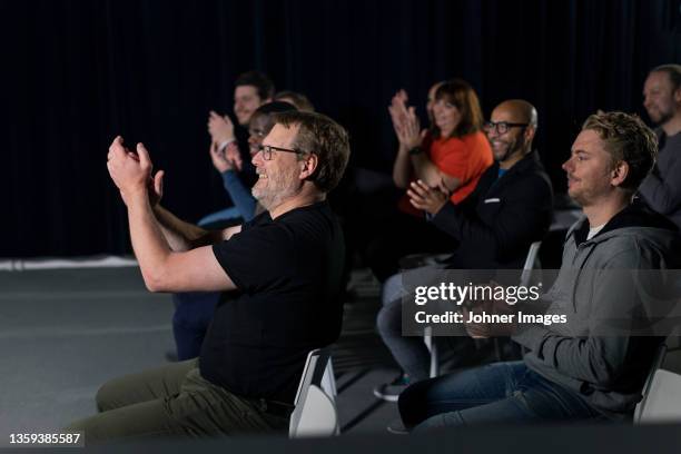 smiling tv show audience clapping - tv audience stock pictures, royalty-free photos & images