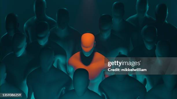 faceless person stands in a crowd and glows dangerously - avoid danger stock pictures, royalty-free photos & images