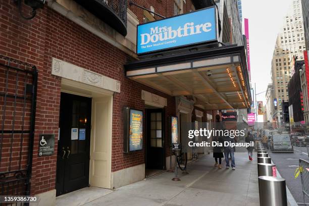 People walk under the "Mrs. Doubtfire" marquee at the Stephen Sondheim Theatre on December 16, 2021 in New York City. Several shows, including "Mrs....