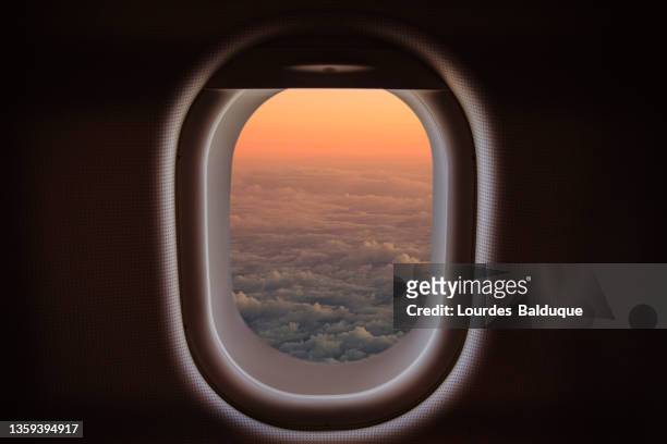 airplane window with sunset sky with clouds - madrid aerial stock pictures, royalty-free photos & images