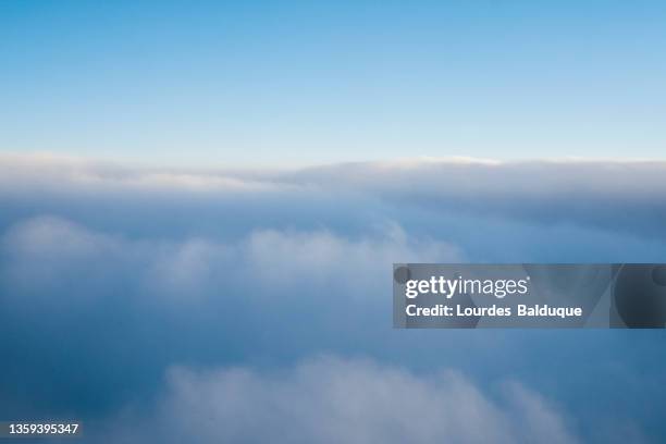 aerial shot of blue sky with clouds - above clouds stock-fotos und bilder