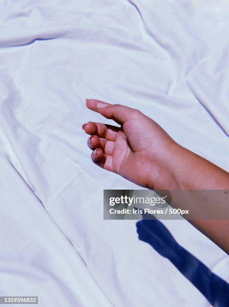 solo quiero alcanzar lo invisible,cropped hand of woman on bed,guatemala - alcanzar stockfoto's en -beelden