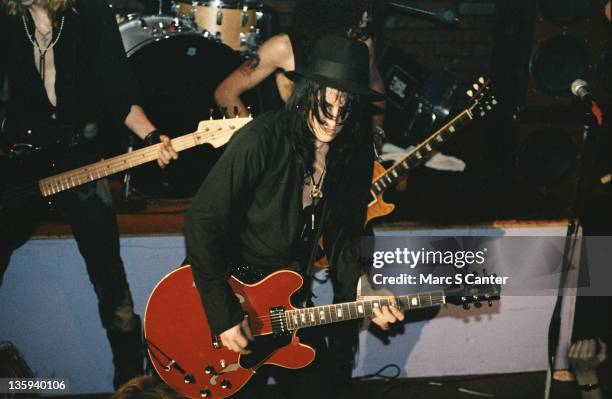 Izzy Stradlin of the rock band "Guns n' Roses" plays a Gibson hollowbody electric guitar as he performs onstage at the Troubadour on January 4, 1986...