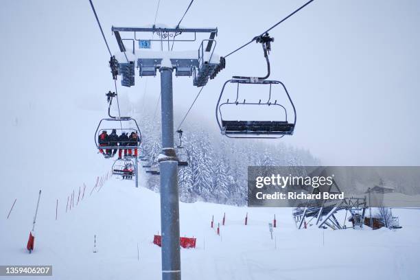 People are seen on a ski lift on December 11, 2021 in Les Arcs, France. French mountain resorts reopen after a 2020 hiatus due to the Covid-19...