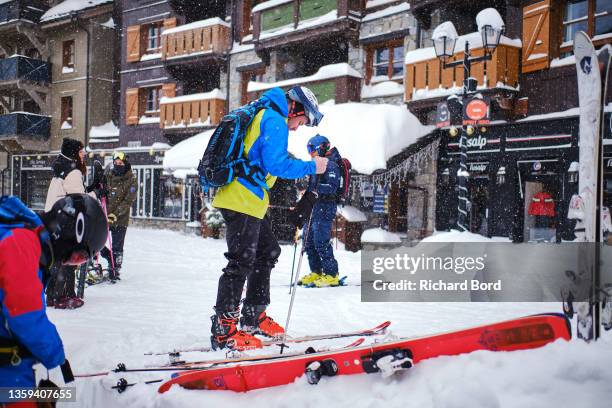 Skiers prepare before going to ski on the slopes on December 11, 2021 in Les Arcs, France. French mountain resorts reopen after a 2020 hiatus due to...