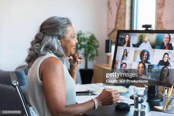 female ceo smiles at employees during teleconference - conference call stock pictures, royalty-free photos & images