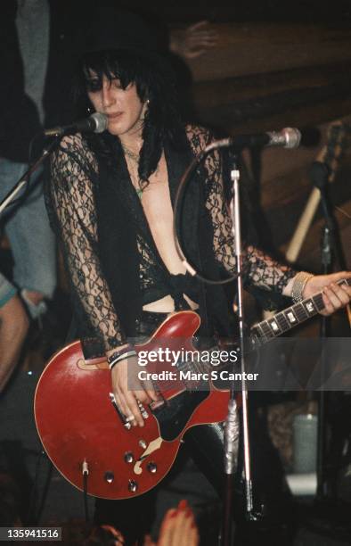 Guitarist Izzy Stradlin performs onstage with the rock band "Guns n' Roses" at the Troubadour with Tom Zutaut of Geffen Records in the audience who...