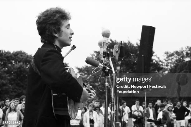 Folk singer Bob Dylan performs at the Newport Folk Festival on July 26, 1964 in Newport, Rhode Island.