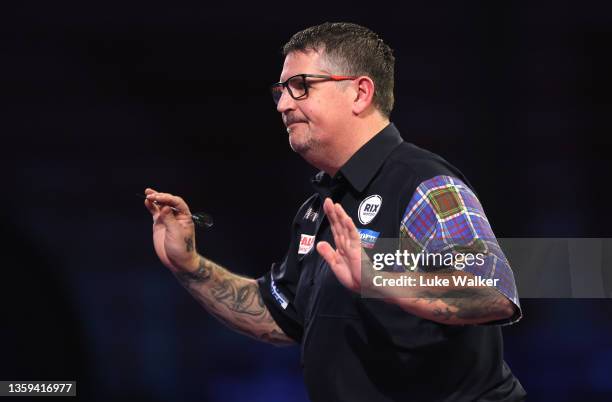 Gary Anderson of Scotland reacts during their Second Round match against Adrian Lewis of England during the William Hill World Darts Championship at...