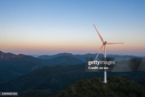 morning drone shot of mountain top industrial wind power plant - windmill stock pictures, royalty-free photos & images