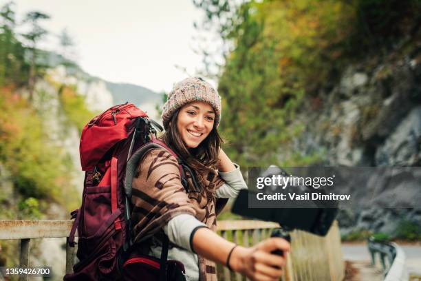 live streaming in the nature. female vlogger explorer. - tourist camera stock pictures, royalty-free photos & images