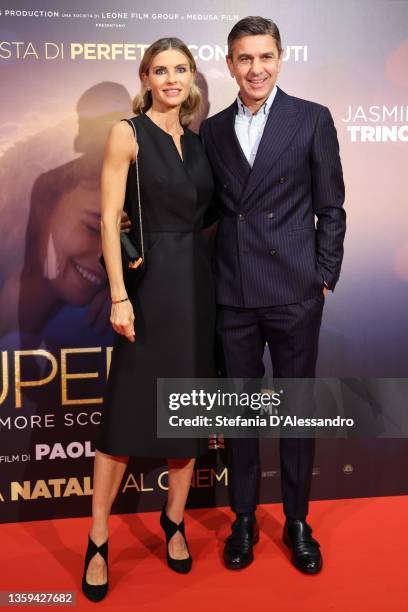 Martina Colombari and Alessandro Costacurta attend the photocall of the movie "Supereroi" at Cinema Odeon on December 16, 2021 in Milan, Italy.