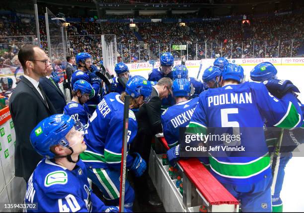 Assistant coach Scott Walker of the Vancouver Canucks talks to players during their NHL game against the Carolina Hurricanes at Rogers Arena December...