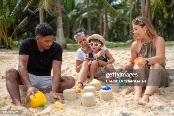 multi generation family playing on beach - philippines family 個照片及圖片檔