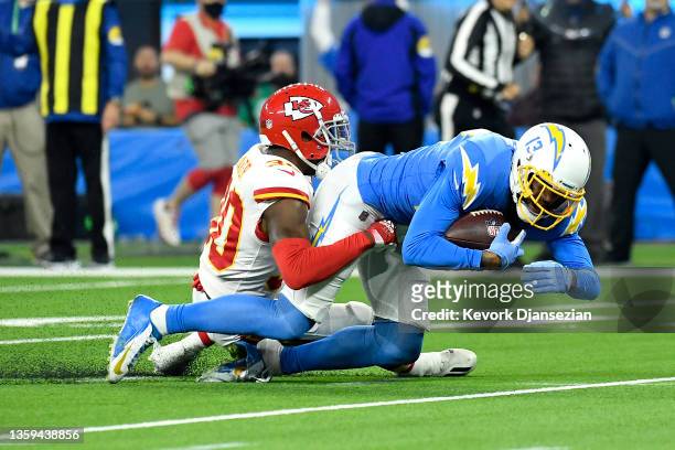 Keenan Allen of the Los Angeles Chargers catches and runs with the ball for a first down against Deandre Baker of the Kansas City Chiefs in the first...