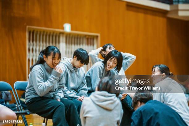 young japanese female college basketball players taking a break - sports activity ストックフォトと画像