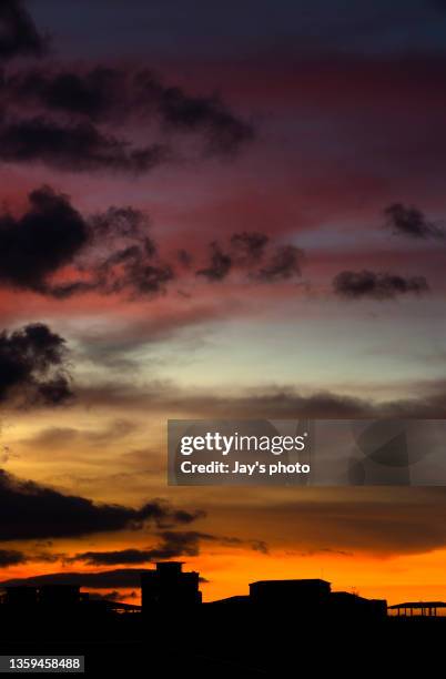 dramatic sunset cloudscape with multiple layers clouds. - daylight saving time 2021 stock pictures, royalty-free photos & images