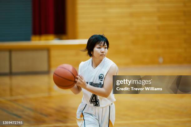 young japanese female college basketball player during a game - womens college basketball stock-fotos und bilder