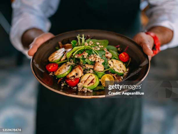 chef offers his prepared vegan salad - quinoa and chickpeas stock pictures, royalty-free photos & images