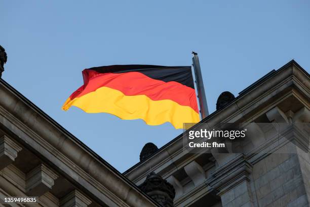 german national flag on the reichstag building (german parliament) in berlin (germany) - tysklands flagga bildbanksfoton och bilder