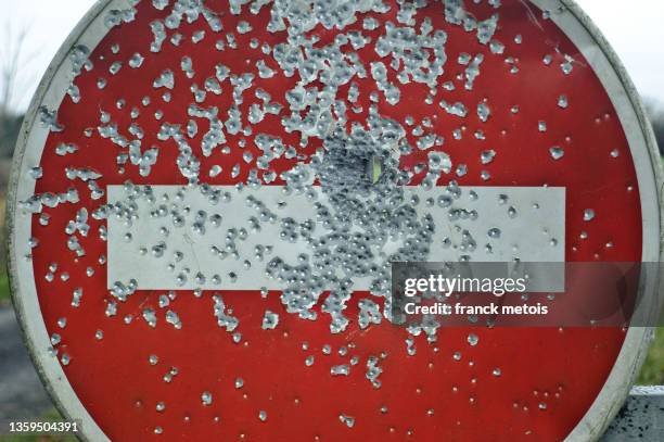 traces of lead shots on a do not enter sign - ammunition stock pictures, royalty-free photos & images