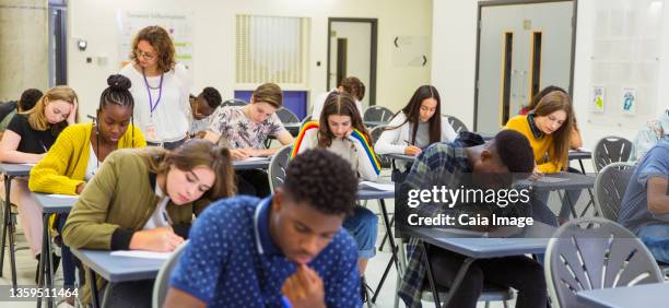 high school teacher supervising students taking exam - secondary school london stock pictures, royalty-free photos & images