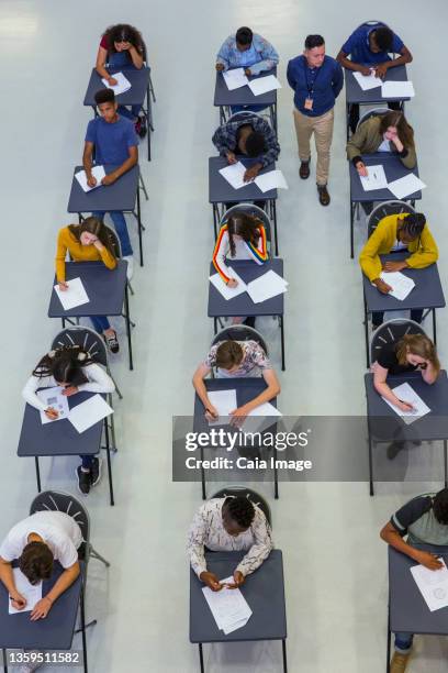 view from above high school teacher supervising students taking exam - gymnasieexamen bildbanksfoton och bilder