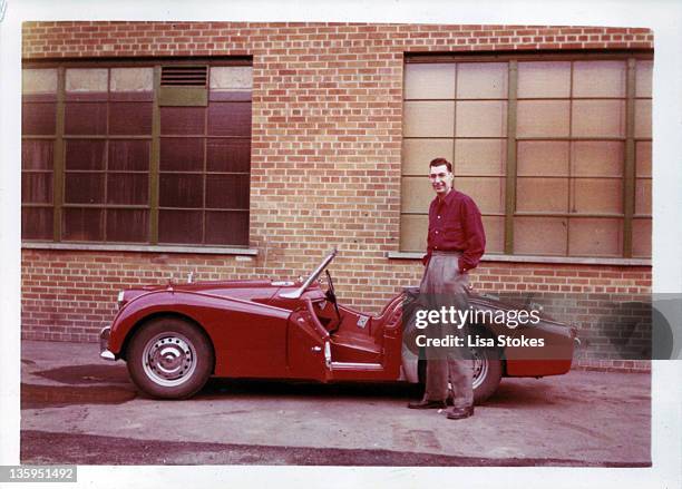 man standing in front of his red sports car - 1950's cars ストックフォトと画像