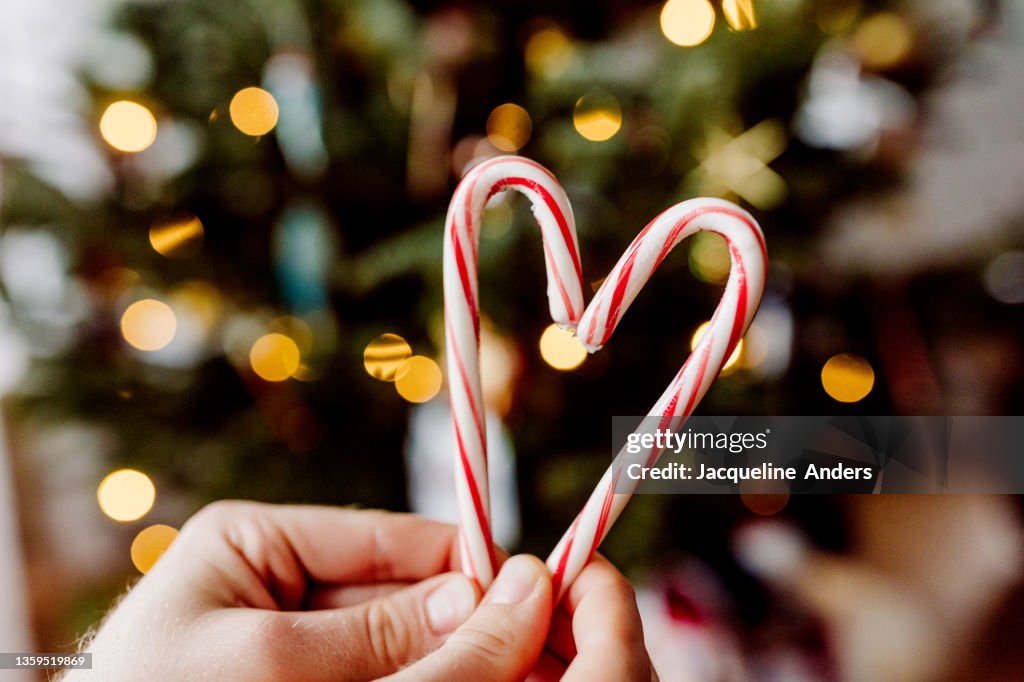 Candy cane heart with Christmas tree lights bokeh