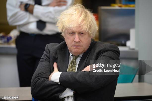 Britain's Prime Minster Boris Johnson speaks with members of the Metropolitan Police in their break room, as he makes a constituency visit to...