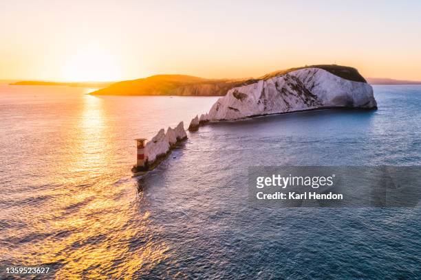 an aerial sunrise view of the needles lighthouse, isle of wight - stock photo - isle of wight stock pictures, royalty-free photos & images