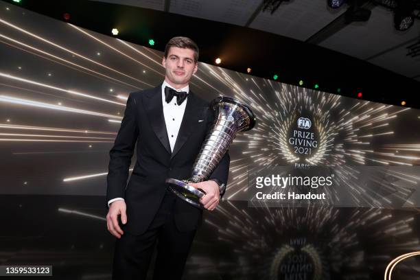 In this handout provided by the FIA, F1 World Drivers Champion Max Verstappen of Red Bull Racing poses with the World Drivers Championship trophy...