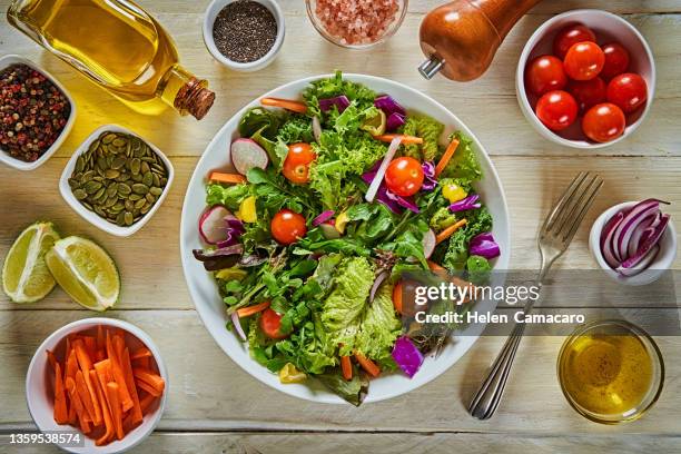 top view of fresh and healthy salad in a bowl on wooden table. - general view stock pictures, royalty-free photos & images