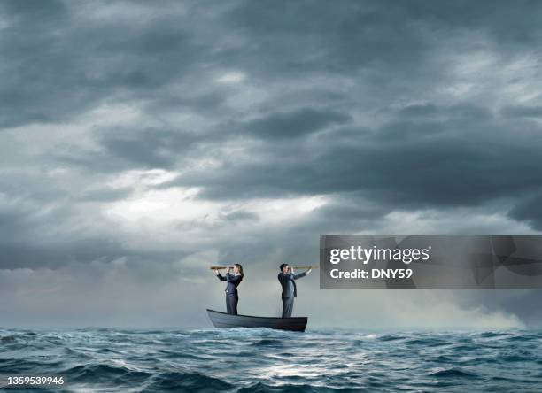 man and woman search for help - sinking rowboat stock pictures, royalty-free photos & images