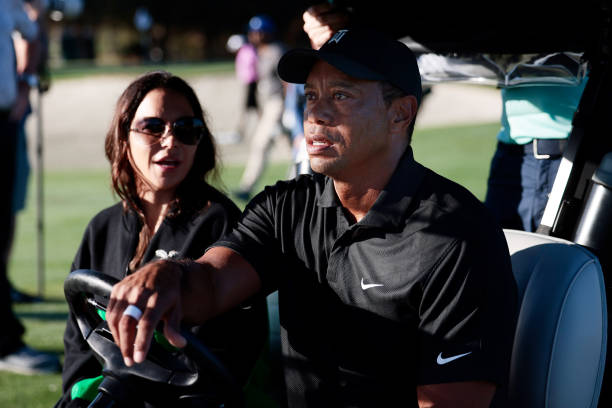 Tiger Woods and Erica Herman ride in a cart prior to the Pro-Am ahead of the PNC Championship at the Ritz Carlton Golf Club Grande Lakes on December...