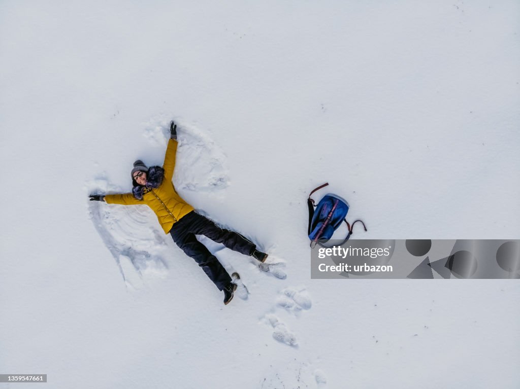 Young Woman Making A Snow Angel