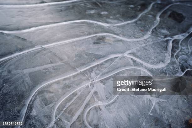 lake with cracked ice sheet - icicle macro stock pictures, royalty-free photos & images
