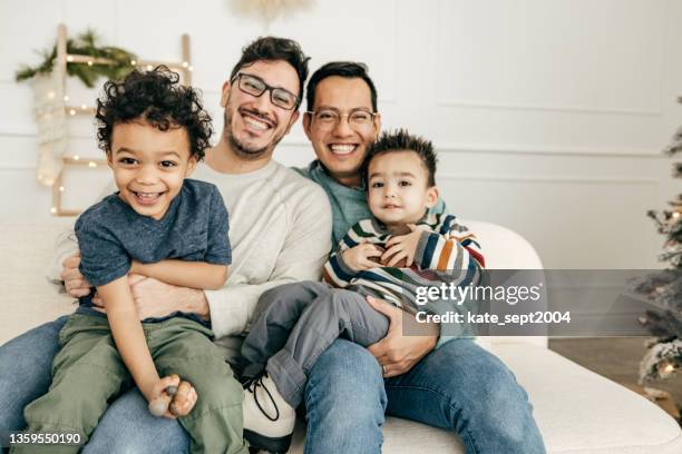 benefits of same sex parenting  - confident and happy children - family group stockfoto's en -beelden