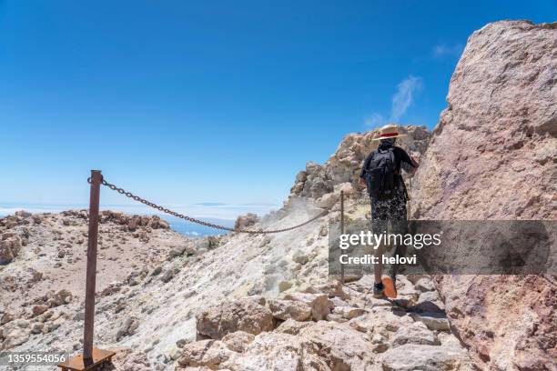 young boy on top of volcano pico de teide, rear view - pico de teide stock pictures, royalty-free photos & images